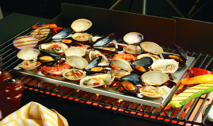The Shellfish Lover's Great Grate loaded with clams, mussels, shrimp and oysters, grilling over hot coals